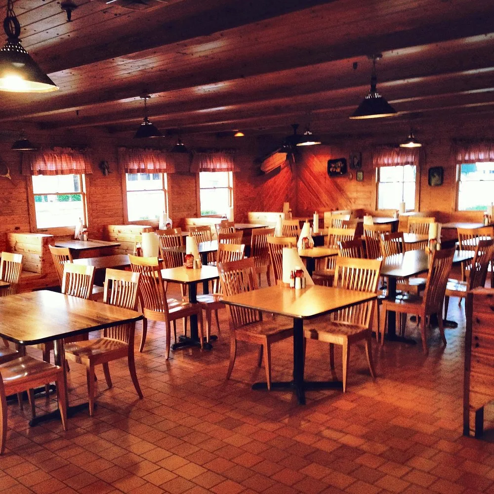 Bar-B-Q King's log-cabin-style dining room, where the original smoke pit still stands